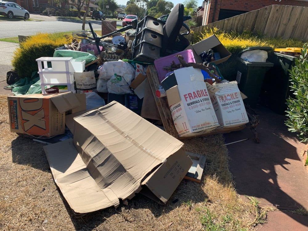Rubbish left for collection on a driveway 