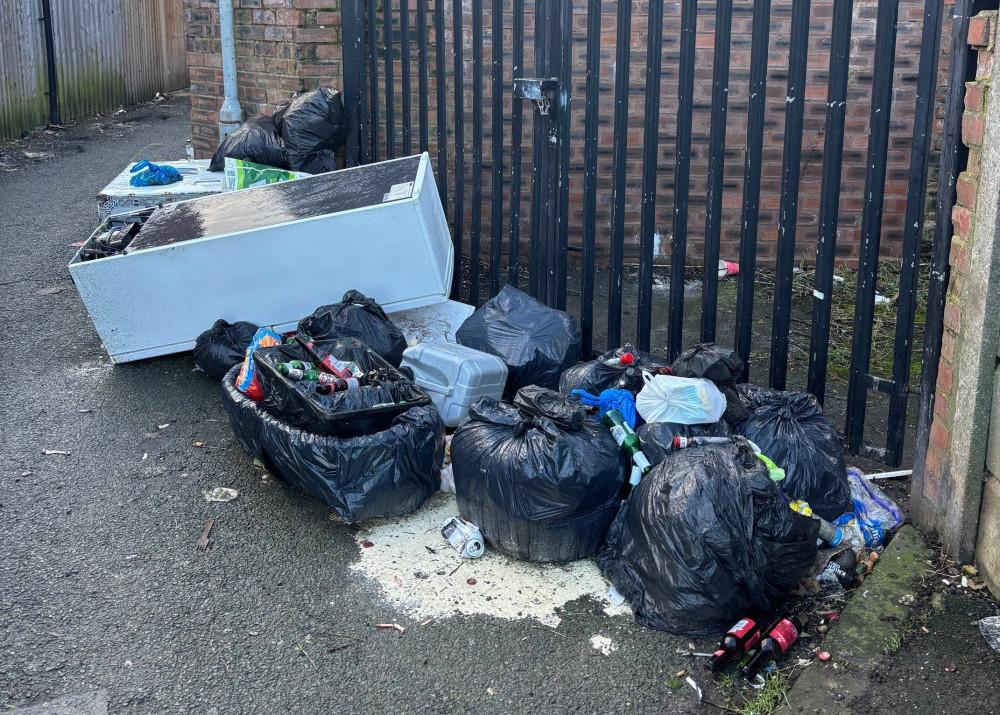 Fly tiping bags of rubbish on pathway