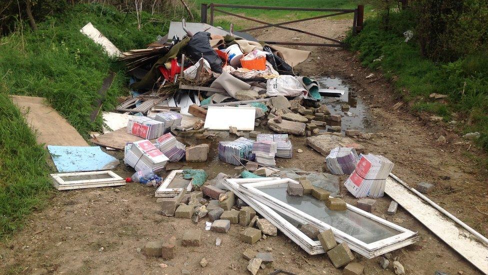 fly tipping of builder's materials on a pathways 