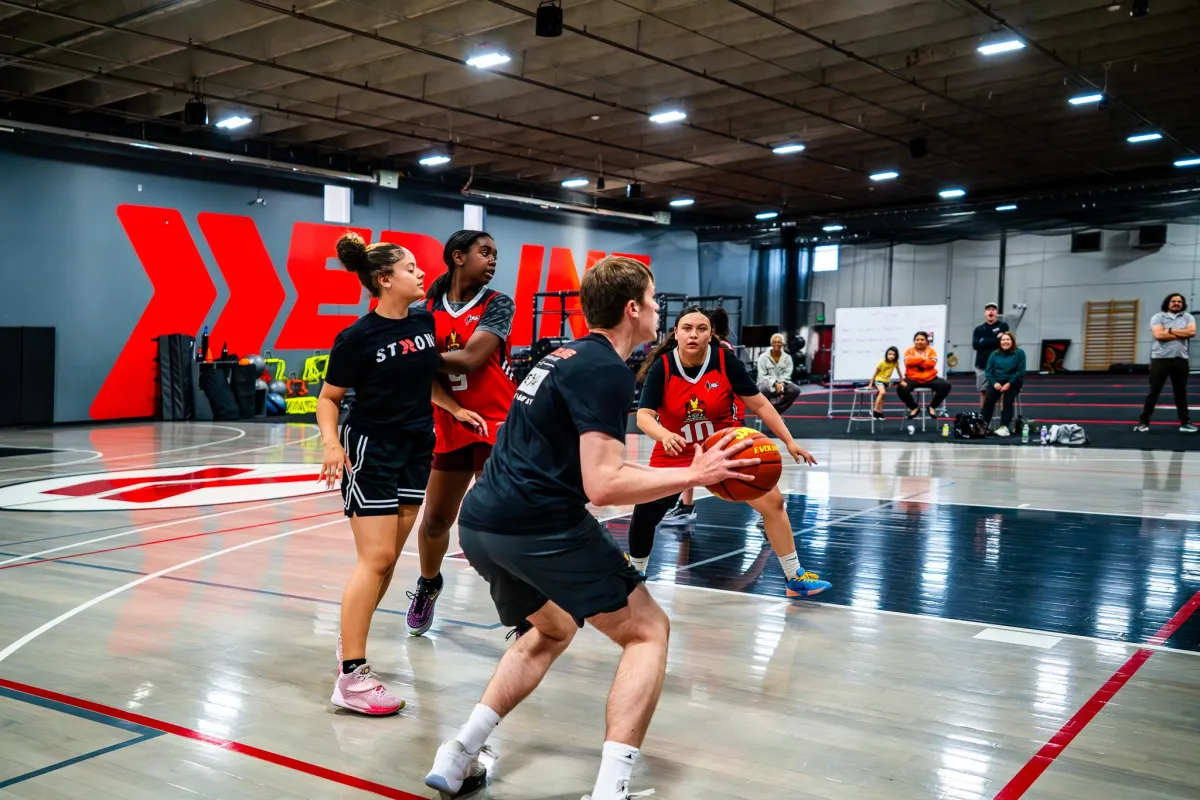 Middle school athletes training in small group basketball drills at Redline Athletics Denver East