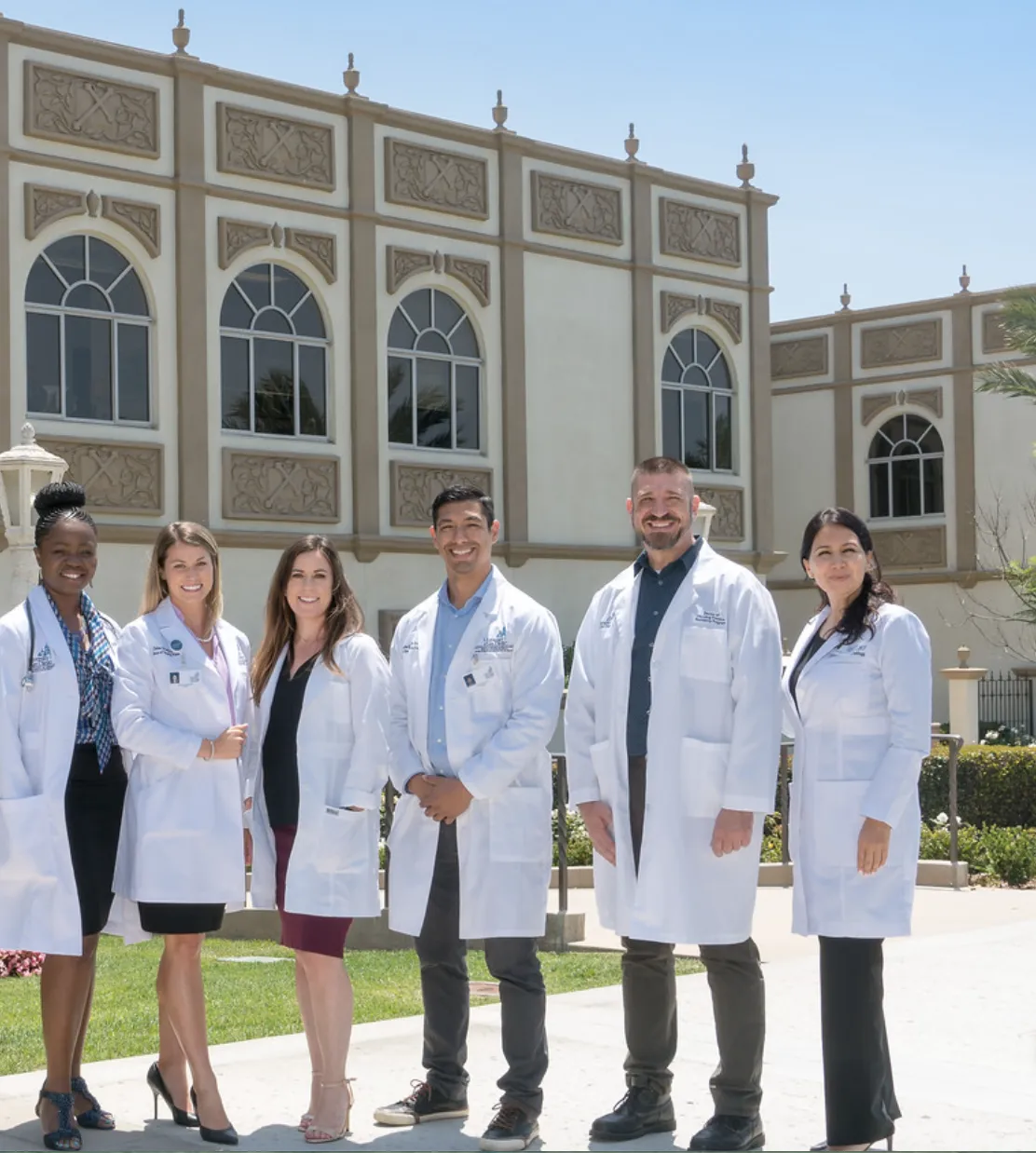 Doctor, girl, and robot in a medical room.