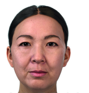 Three women sitting on a couch reading a book