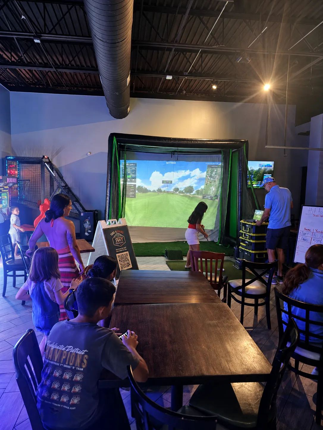 Guest playing the Par-T Mobile Golf simulator at an event
