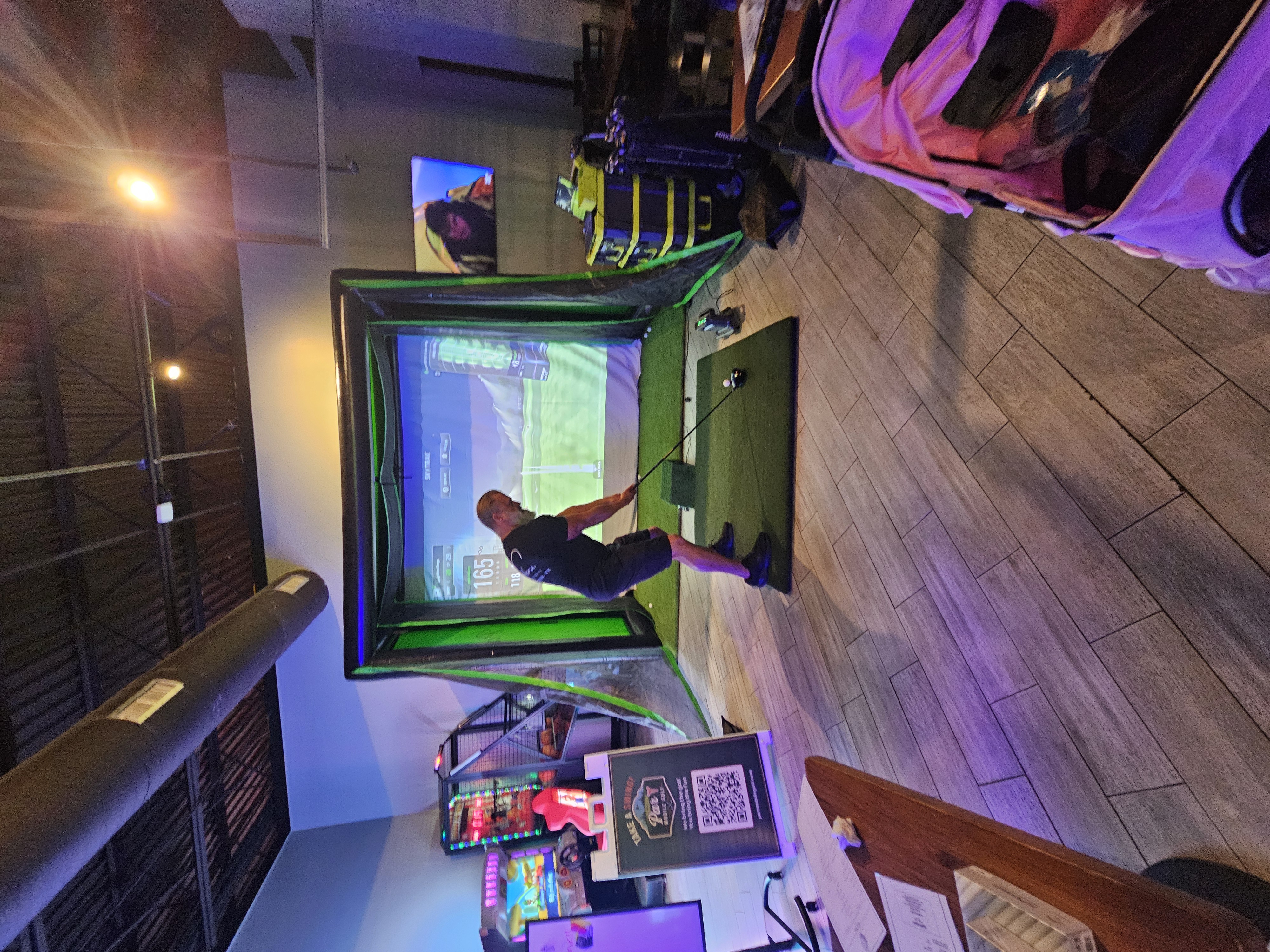 Guest playing the Par-T Mobile Golf simulator at an event