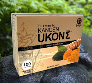 Box of Enagic Kangen Ukon Sigma 100 softgel capsules made with organic Japanese turmeric on a natural stone background