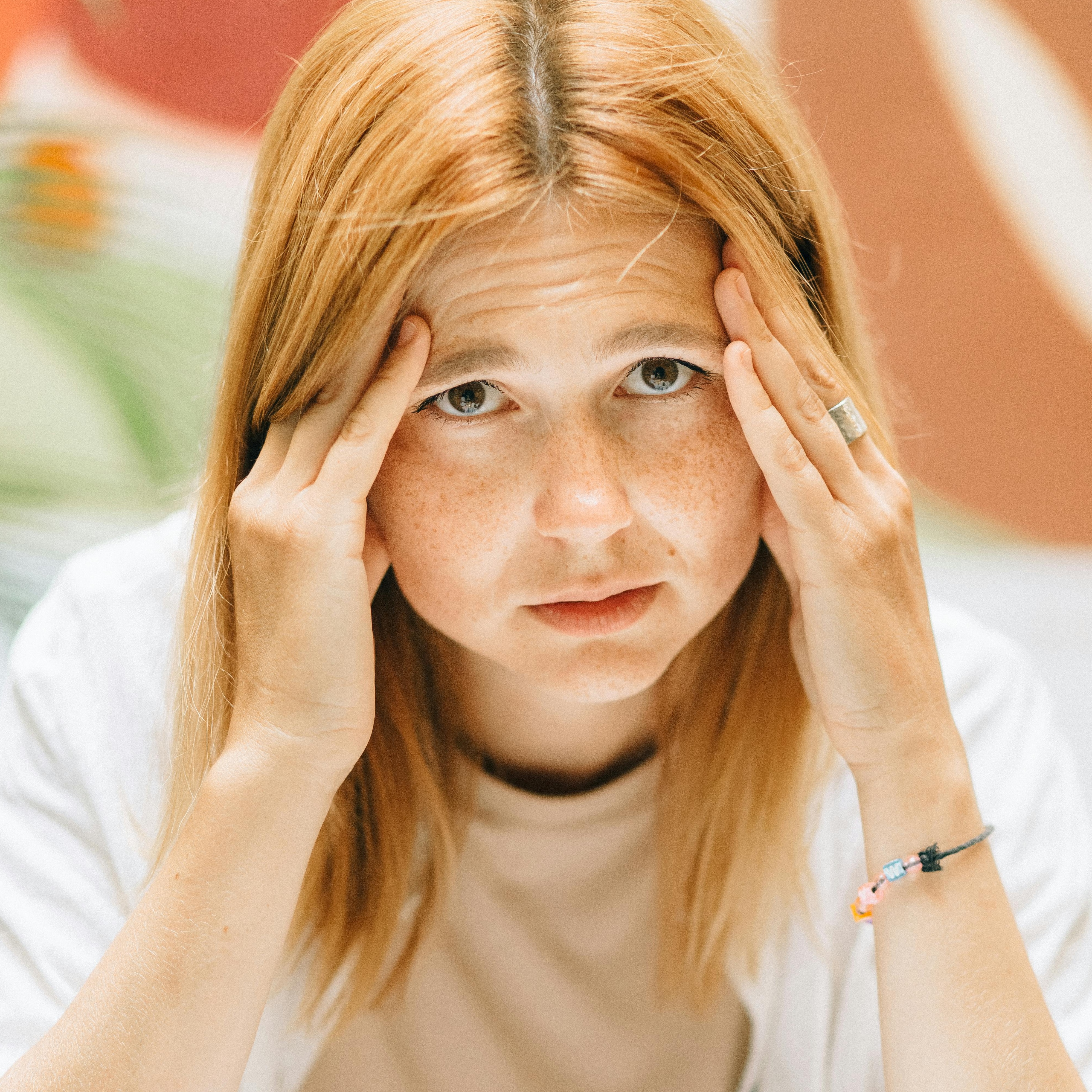 woman rubbing her head