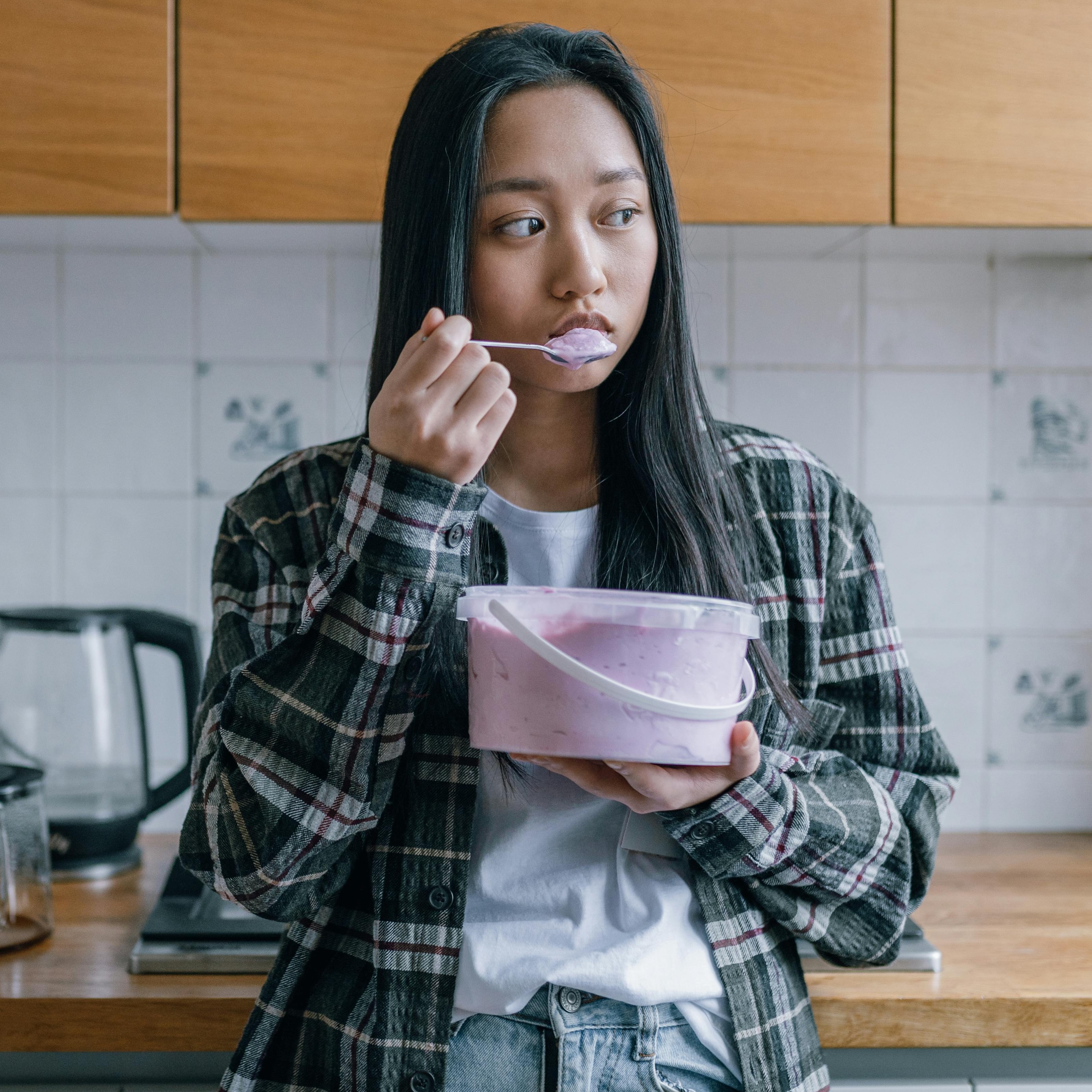 woman eating tub of ice cream