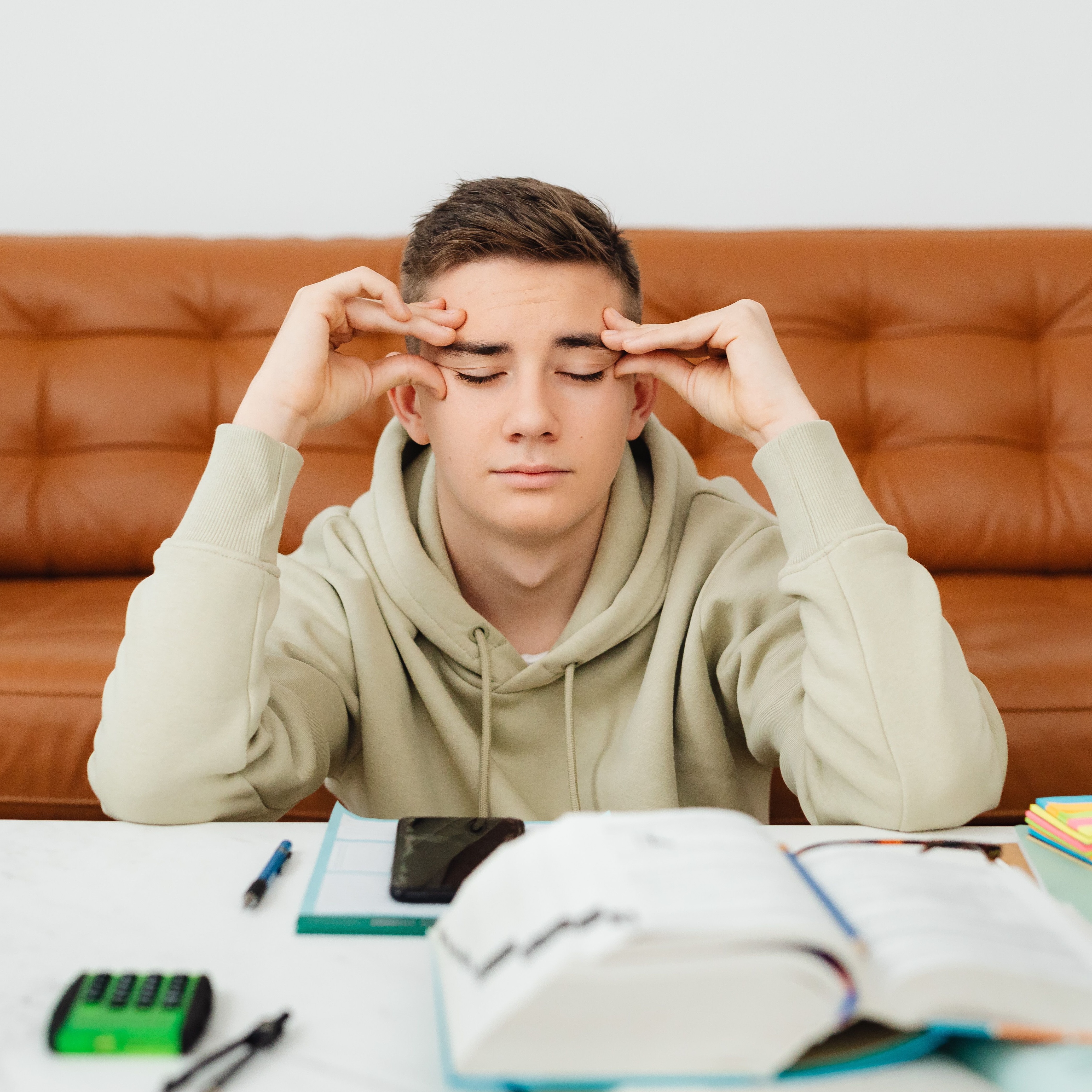 man with books Infront of him