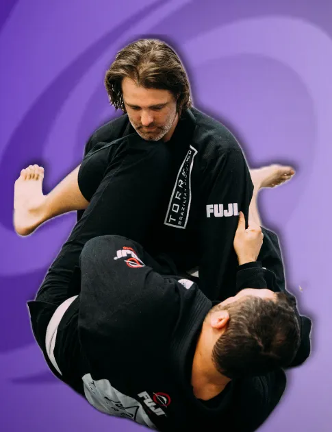 Adult BJJ students grappling to improve flexibility, balance, and strength during training at Torrent Brazilian Jiu-Jitsu in Hanover Pembroke, MA
