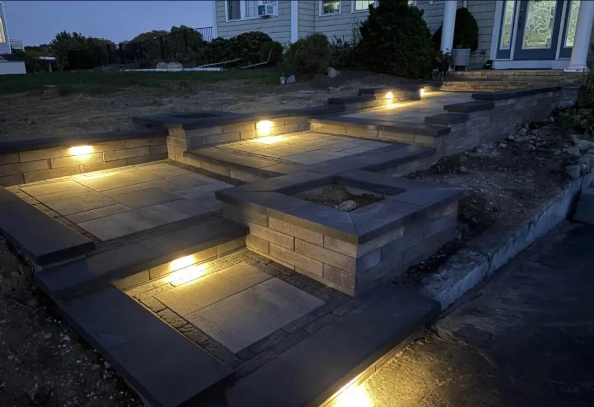 Block steps and seat walls with landscape lighting on a finished hardscape