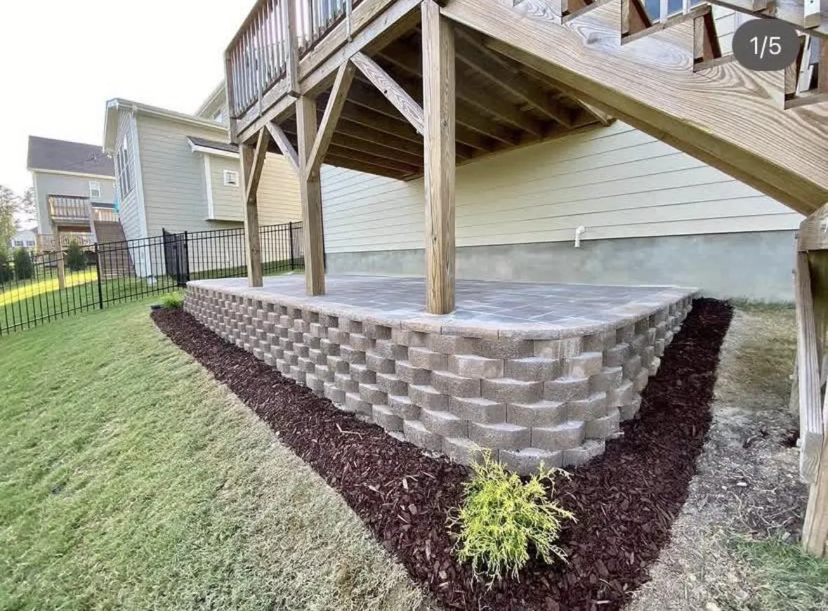 Block landscape wall with mulch bed under an elevated deck in the Triangle, NC
