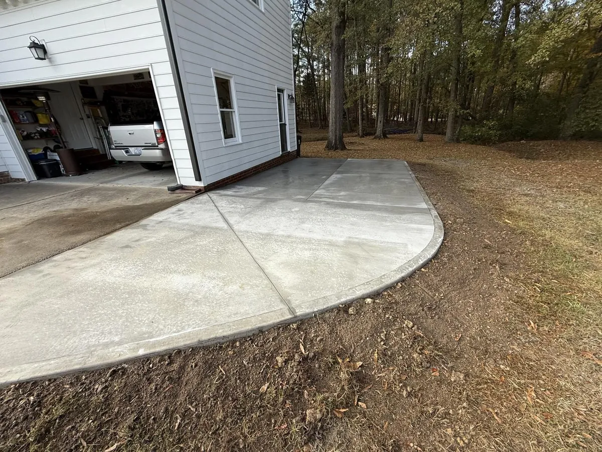 New concrete driveway extension beside a garage in Holly Springs, NC