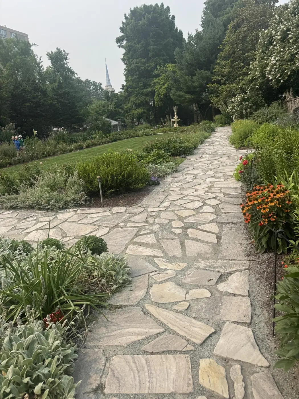 Irregular flagstone walkway winding through planted garden beds in the Triangle, NC