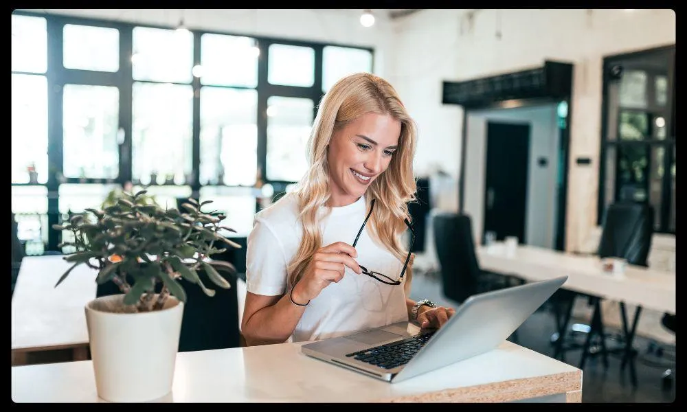 Woman smiling at laptop