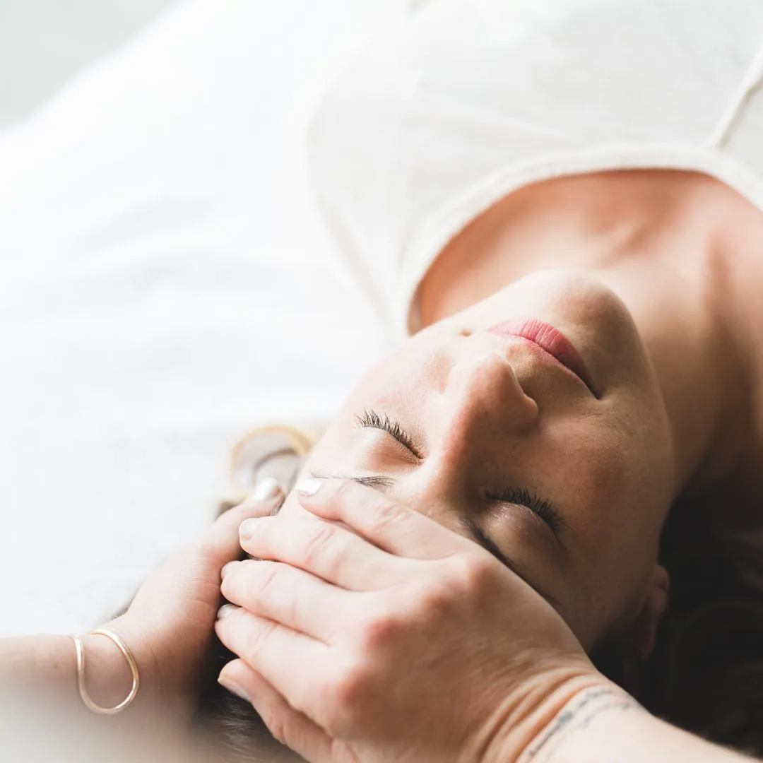 relaxed woman receiving reiki