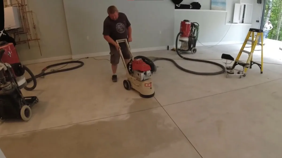 Grinding residential concrete floor prior to epoxy application by Devonport Epoxy Flooring in Devonport, TAS.