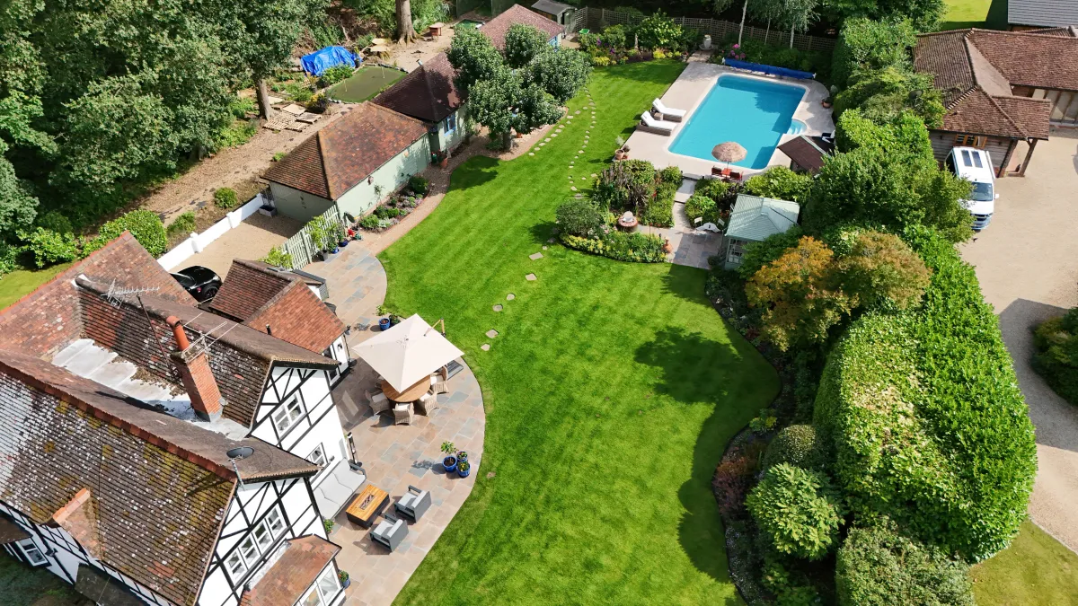 Aerial photo of a house with a swimming pool.