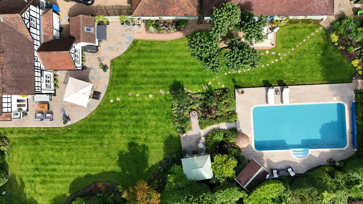 Birds eye view of a property with a swimming pool.