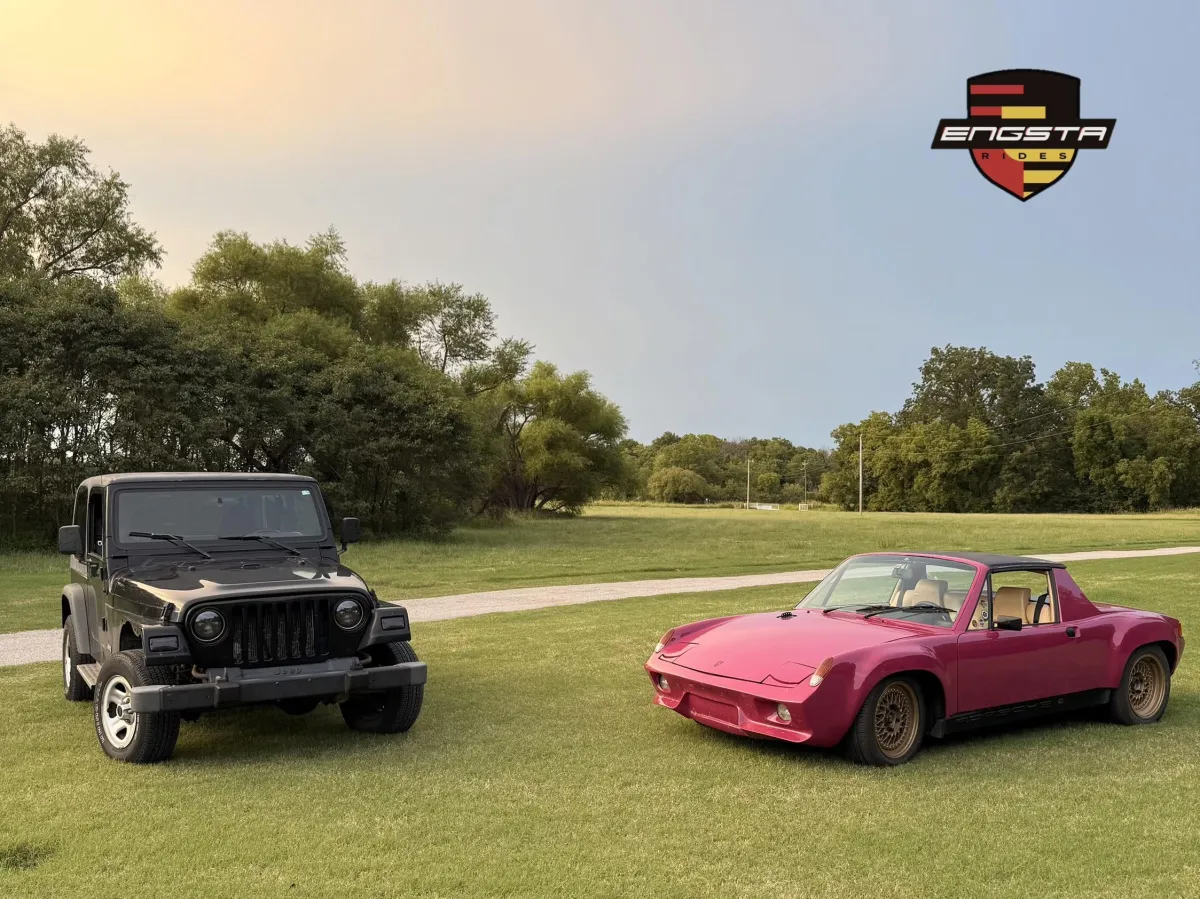 front view of a green Jeep and a pink Porsche 914
