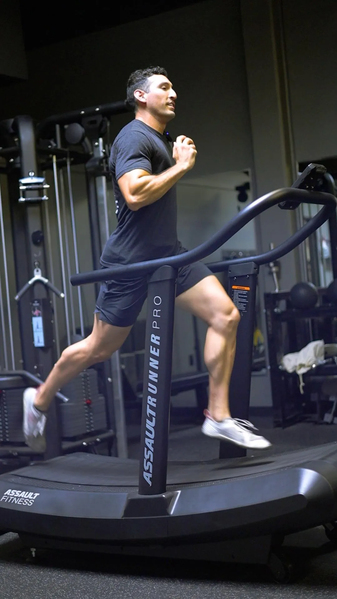 Trainer sprinting on AssaultRunner Pro treadmill for group run club workout