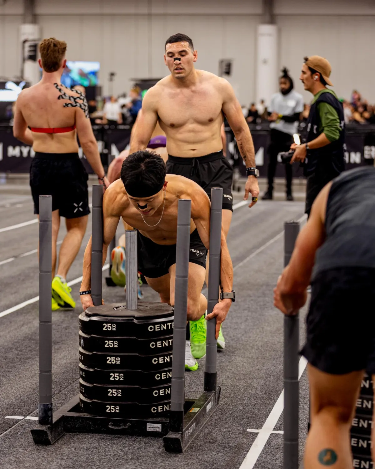 Coach Daniel Performing sled push as Adan looks on