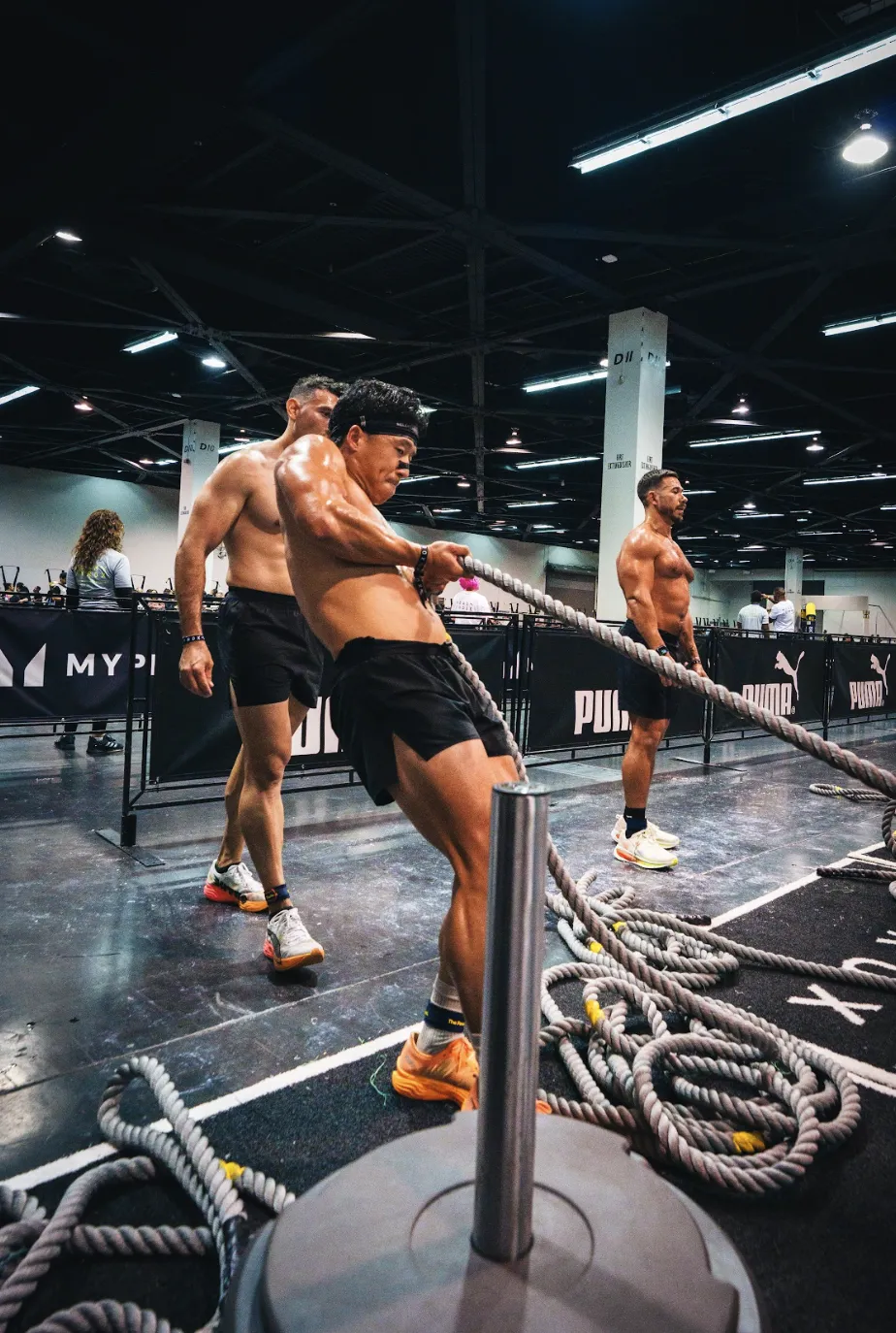 Coach Daniel performing sled pulls at HYROX event