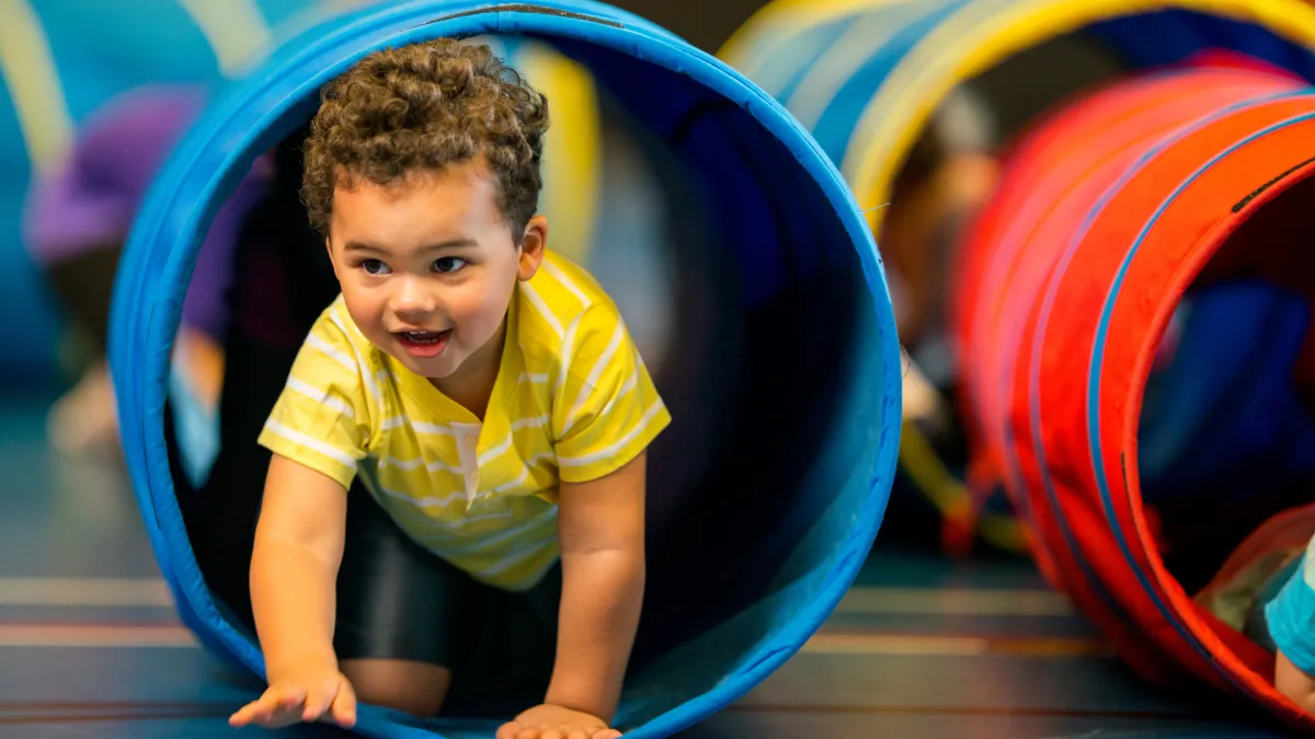 Woman does pilates upside down on equipment.