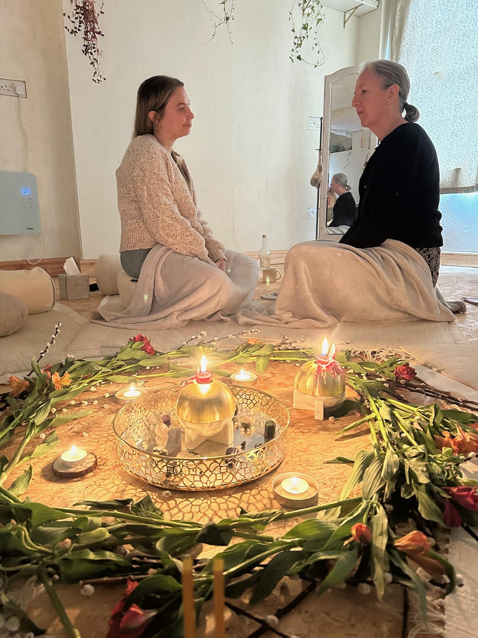 women and candles sitting comfortably