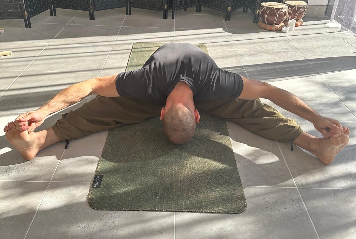 a small buddha statue sitting on top of a body of water