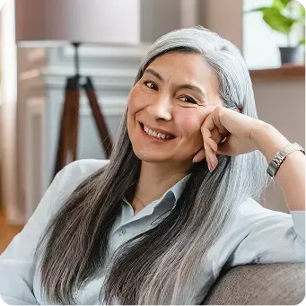 Smiling woman on a couch.
