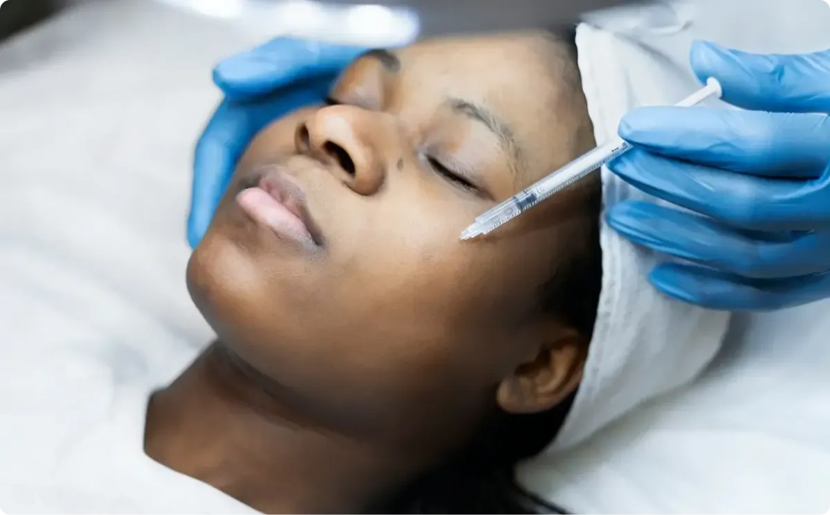 Female patient getting regenerative injection on face.