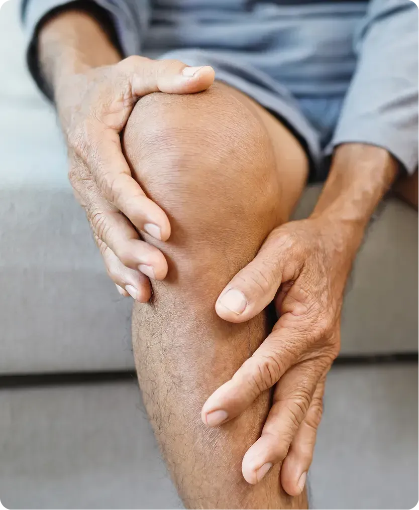 Man holding injured knee that needs prolotherapy.