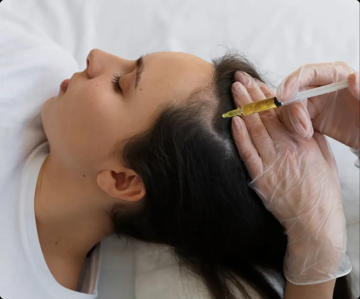 Female patient receiving platelet-rich plasma injection.