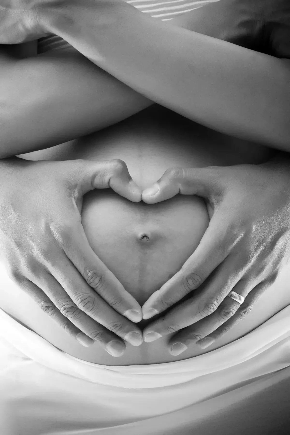 A woman's hands on her pregnant belly.