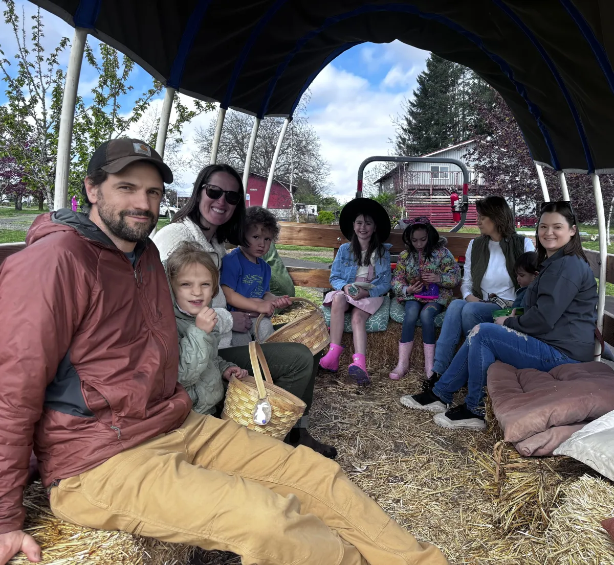 Family riding in a hay wagon
