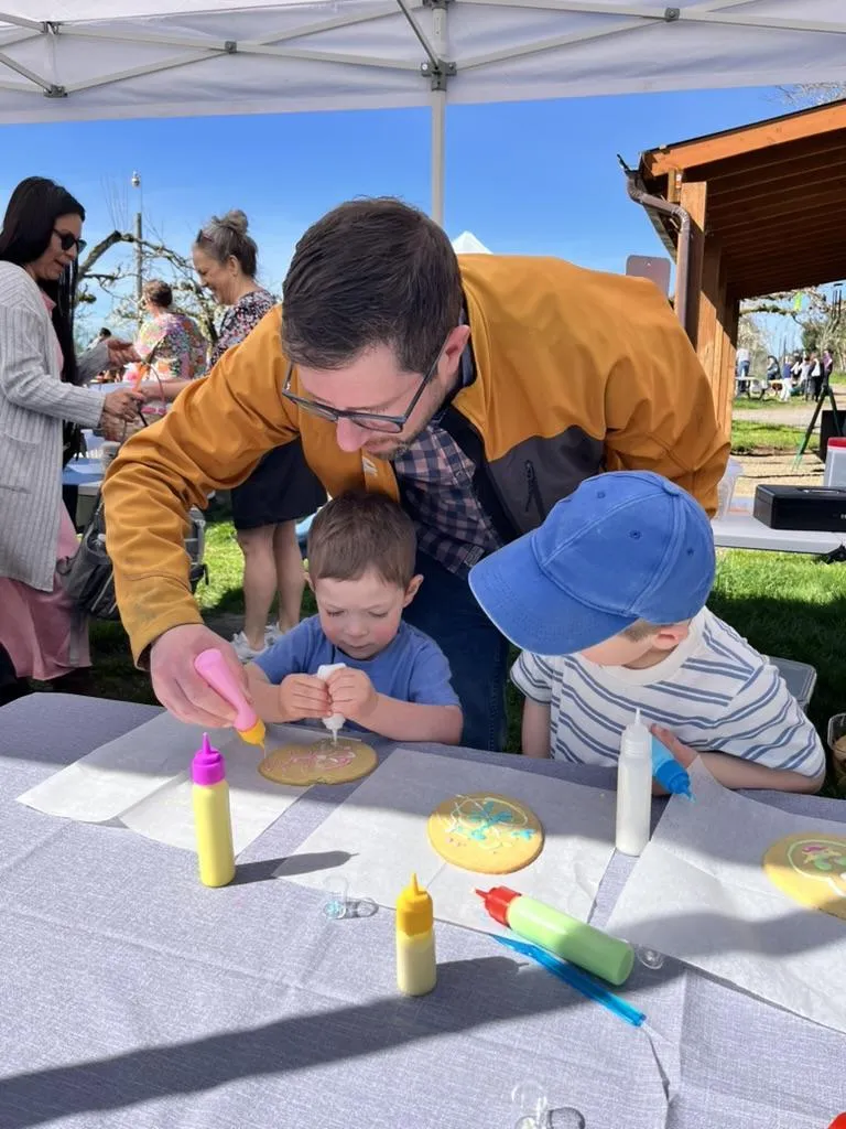 Parent decorating cookies with kids