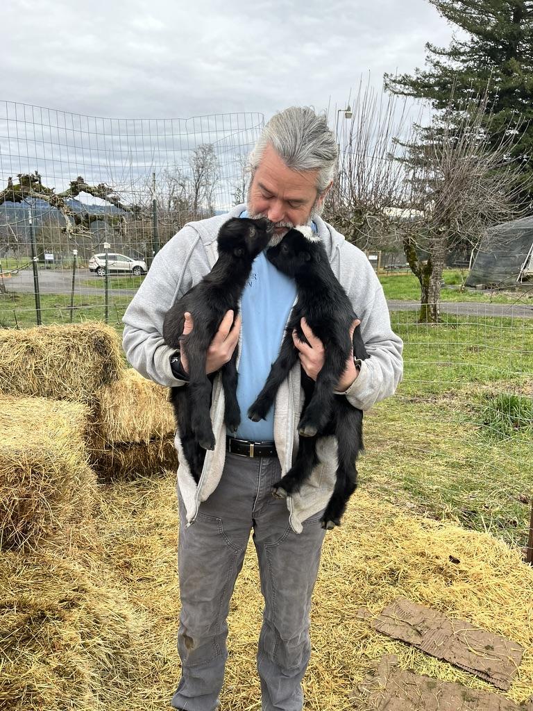 John holding two baby goats