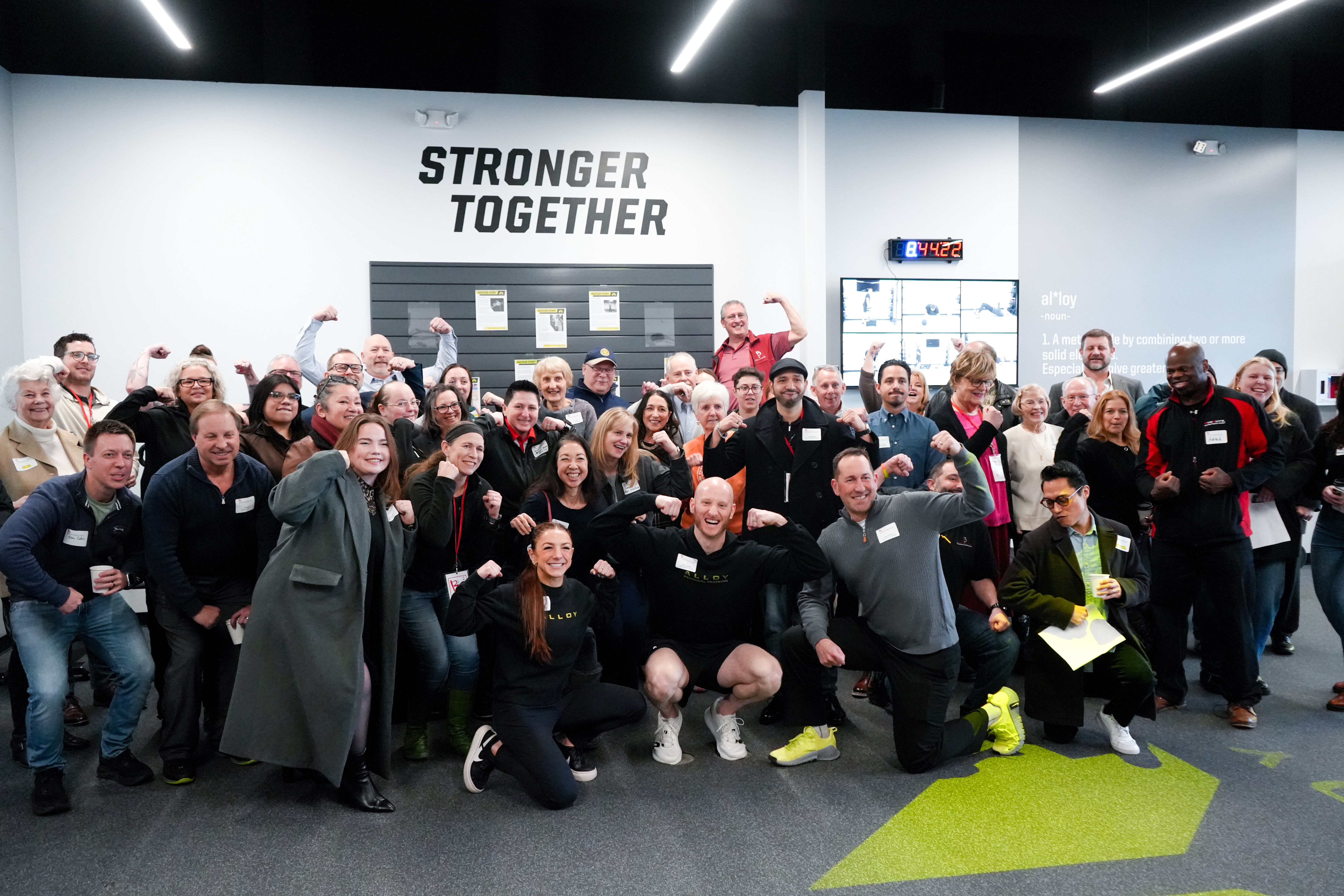 Certified personal trainers at Alloy Personal Training Cedar Hills Crossing posing in a small group strength training studio designed for adults over 40.