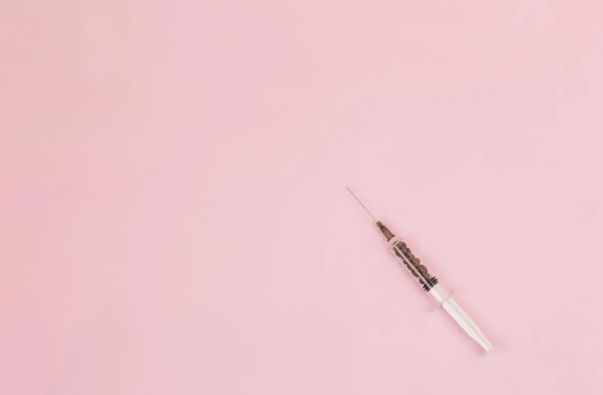 Syringe on pink backgound