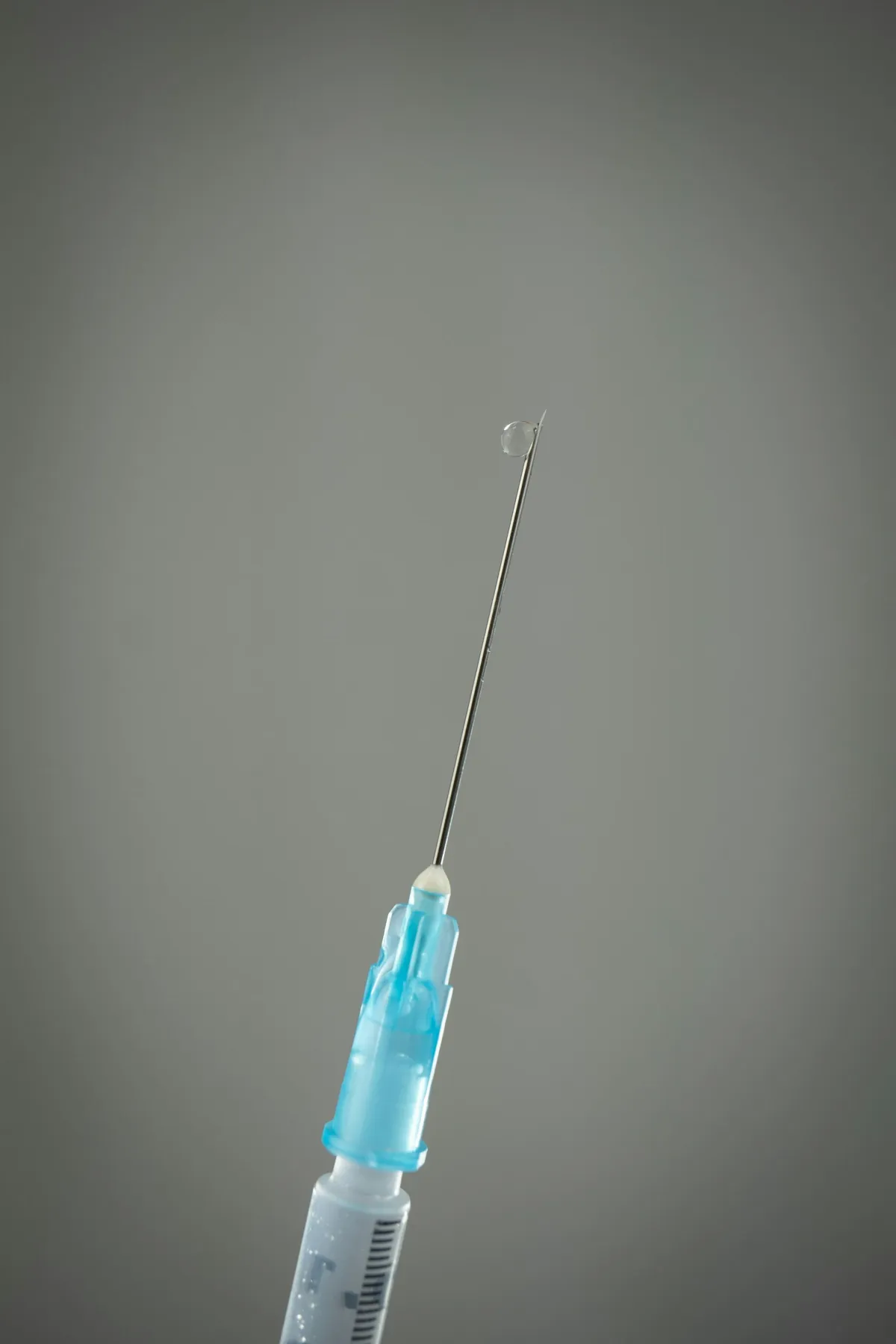 syringe on gray background