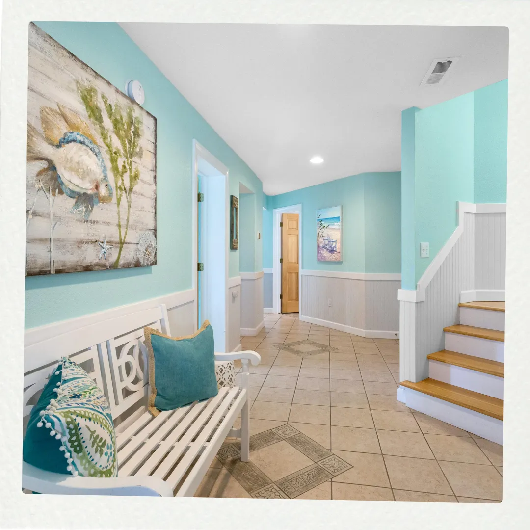 Phoenix Paintworks interior painting expertise in Mildura demonstrated through this coastal-themed entryway with beautifully executed aqua feature walls, crisp white paneling, and professional paint application creating a welcoming entrance space.