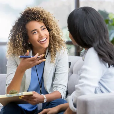 Parent participating in an in-home autism therapy session with a BCBA, learning coaching strategies and at-home tools.