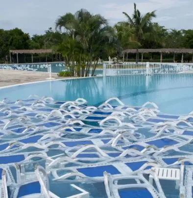 Patio lounge chairs sunk in a pool to protect them from hurricane winds, a common Fort Pierce storm prep step