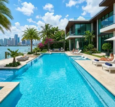 Luxury waterfront pool with lounge chairs and tropical landscaping kept clean by Fort Pierce Pool Maintenance