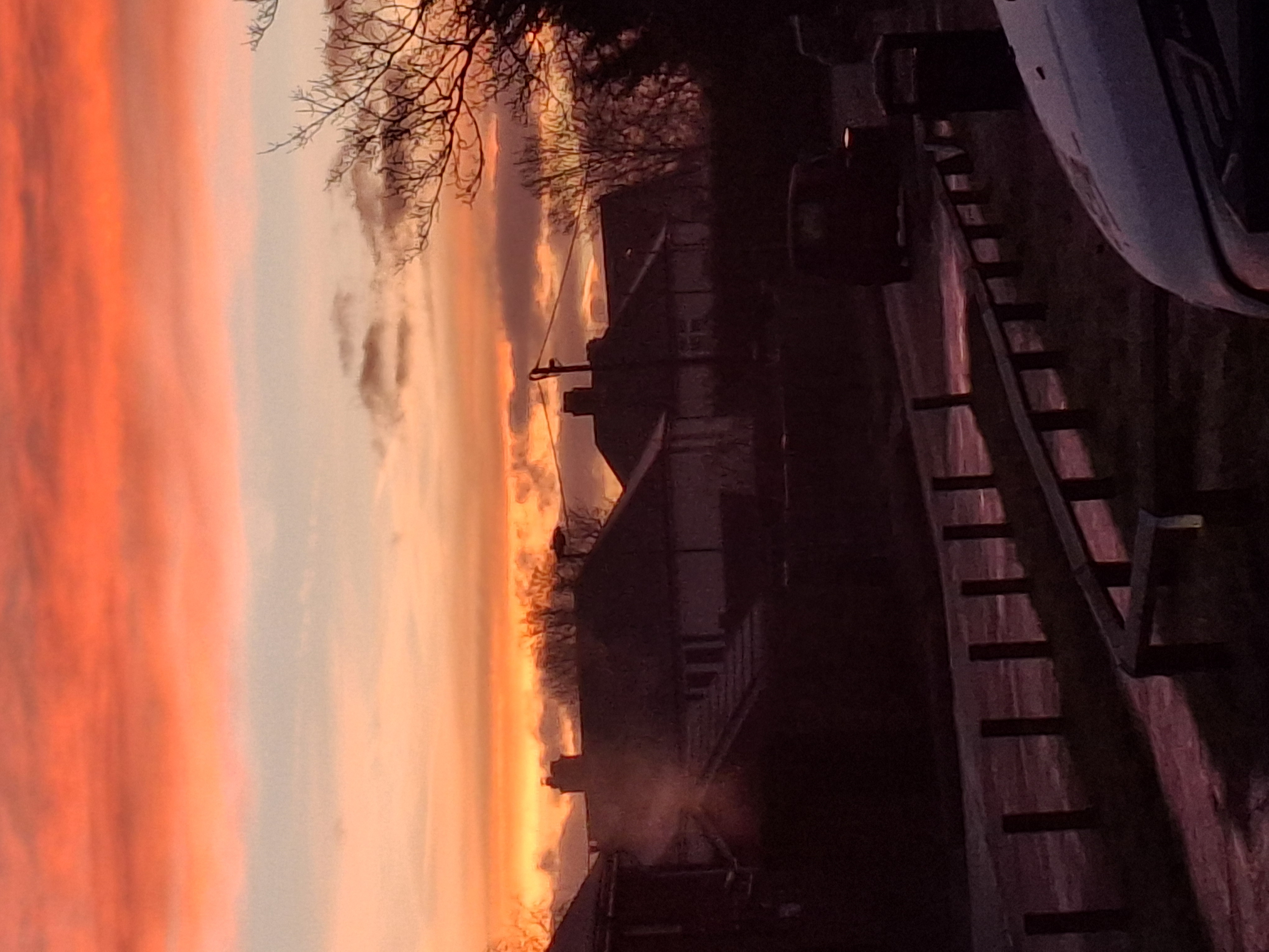 sunrise over a residential area, pink and orange sky