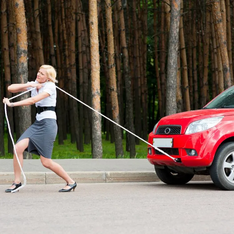 Women pulling car