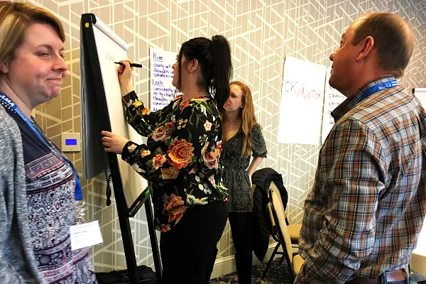 Leadership team analyzing strategic assumptions and decision consistency before organizational execution breakdown