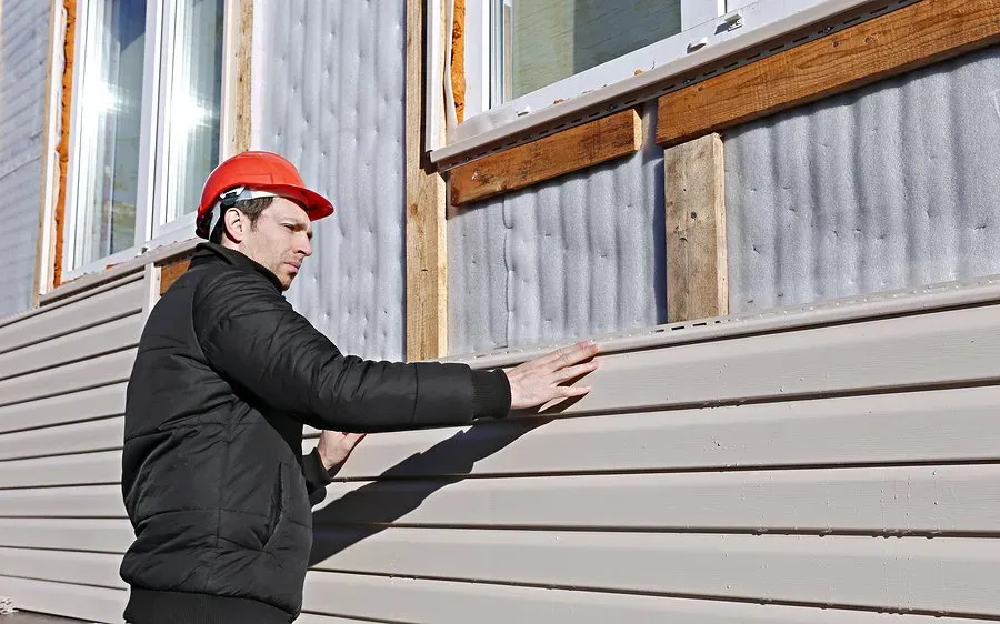 worker checking the siding