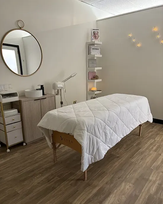 Portrait of the clinic founder in a softly lit treatment suite, professional and approachable.