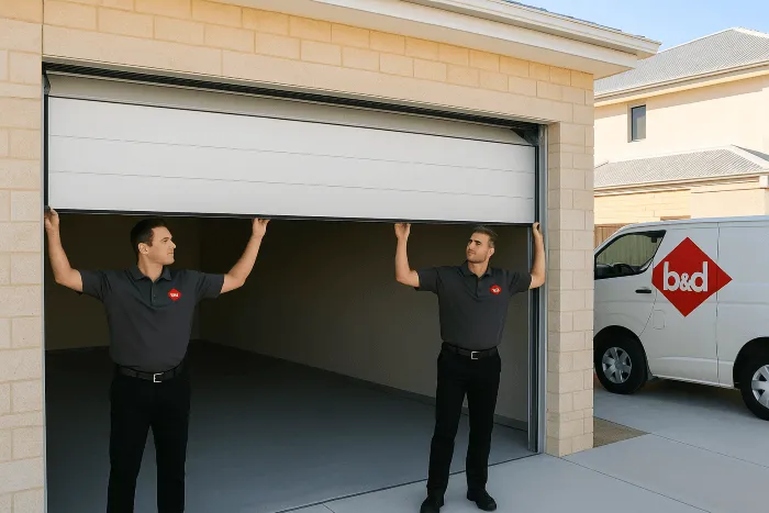 two men in B&D uniform's installing a garage door 